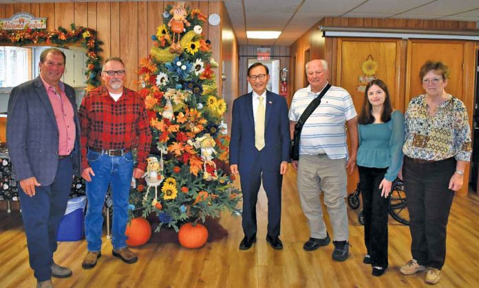 Maxine Catteau, Larry Catteau, Madie Barker, Minister Raymond Cho, and MPP Paul Vickers discussing the Seniors Active Living Centre Program.