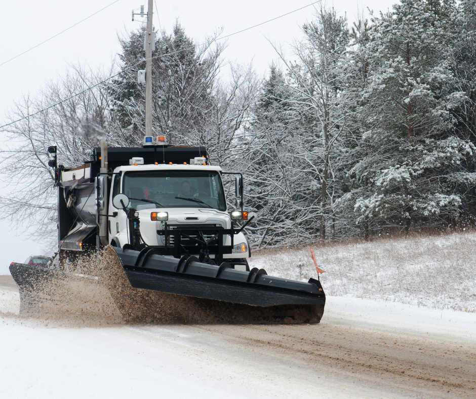 Photo of a snow plow clearing snow off a road. 