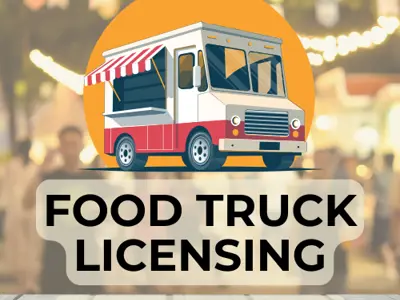 Picture of a red and white Food Truck with lights in the background.